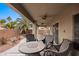 Outdoor patio with a ceiling fan, a seating area, and a view of the backyard landscaping at 870 Santa Maria Way, Mesquite, NV 89027