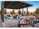 Stylish outdoor lounge area featuring modern furniture, a shade structure, and landscaped surroundings at 9561 Jadeite Ln, Las Vegas, NV 89143