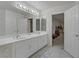 Bathroom with double sink vanity, large mirror, and tile flooring at 10899 Royal Highlands St, Las Vegas, NV 89141