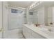 Bright bathroom features a shower-over-tub with glass doors and double sink vanity at 10899 Royal Highlands St, Las Vegas, NV 89141