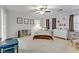 Bright bedroom featuring a ceiling fan, plush carpet, and large windows at 10899 Royal Highlands St, Las Vegas, NV 89141