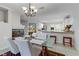 Bright dining room with a glass table, white chairs, and an open layout with a view to the kitchen area at 10899 Royal Highlands St, Las Vegas, NV 89141