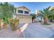 Charming home with a two-car garage, red shutters, a palm tree, and a brick driveway at 10899 Royal Highlands St, Las Vegas, NV 89141