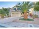 Well-maintained home with a palm tree in the front yard, brick driveway, and two-car garage at 10899 Royal Highlands St, Las Vegas, NV 89141