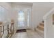 Welcoming foyer features a decorative front door, tile flooring, and a staircase to the upper level at 10899 Royal Highlands St, Las Vegas, NV 89141