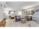 Comfortable living room features neutral decor, plantation shutters, and a view into other living spaces at 10899 Royal Highlands St, Las Vegas, NV 89141