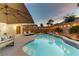 Inviting pool area with lounge chairs, patio seating and lush landscaping at 10899 Royal Highlands St, Las Vegas, NV 89141