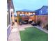 Backyard, featuring artificial grass, paver patio, outdoor seating, and a wooden pergola at 10976 Bluebell Basin Rd, Las Vegas, NV 89179