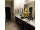 Bright bathroom featuring a double sink vanity with ample counter space and contemporary lighting at 10976 Bluebell Basin Rd, Las Vegas, NV 89179