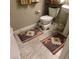 Small bathroom featuring a white toilet, small sink, and southwestern rugs at 10976 Bluebell Basin Rd, Las Vegas, NV 89179