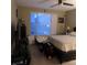 Cluttered bedroom featuring a window with blinds and neutral colored walls at 10976 Bluebell Basin Rd, Las Vegas, NV 89179