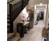 View of an entryway with tiled floors, a staircase, and view into the living room at 10976 Bluebell Basin Rd, Las Vegas, NV 89179