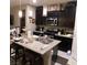 Open kitchen featuring a breakfast bar island, granite countertops, and dark cabinetry at 10976 Bluebell Basin Rd, Las Vegas, NV 89179