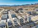 An aerial shot displays rows of new homes in a planned community against a mountain backdrop at 11576 Ashy Storm Ave, Las Vegas, NV 89138