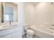 Bathroom features a tub with tiled wall and a modern vanity with stone countertop at 11576 Ashy Storm Ave, Las Vegas, NV 89138