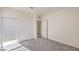 Carpeted bedroom features a closet and a doorway leading to another room at 11576 Ashy Storm Ave, Las Vegas, NV 89138