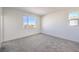 Bright bedroom showcasing neutral carpet, fresh white paint, and a large window allowing for natural light at 11576 Ashy Storm Ave, Las Vegas, NV 89138