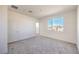 Bedroom featuring neutral carpet, fresh paint, a window, and doors leading to a walk-in closet and bathroom at 11576 Ashy Storm Ave, Las Vegas, NV 89138