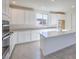 Contemporary kitchen featuring white cabinetry, an island, and tile floors at 11576 Ashy Storm Ave, Las Vegas, NV 89138