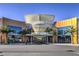 An open-air mall entrance with modern architecture and lush landscaping at 11576 Ashy Storm Ave, Las Vegas, NV 89138