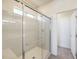 Shower featuring a glass enclosure, built-in bench, and a clear glass door leading to a secondary room at 11576 Ashy Storm Ave, Las Vegas, NV 89138