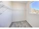 Carpeted walk-in closet with wire shelving and a window offering natural light and views of the nearby mountain at 11576 Ashy Storm Ave, Las Vegas, NV 89138