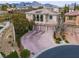 Beautiful aerial view of home with mountain views and a three-car garage at 12118 La Carta Ct, Las Vegas, NV 89138