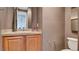 Powder room featuring a wood vanity, granite countertop and tile flooring at 12118 La Carta Ct, Las Vegas, NV 89138