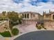 Stunning exterior elevation of a two-story home showcasing a three-car garage and landscaped front yard at 12118 La Carta Ct, Las Vegas, NV 89138