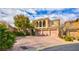 Beautiful two-story home featuring a three-car garage and lovely landscaping at 12118 La Carta Ct, Las Vegas, NV 89138