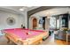 Open-concept game room with a pool table, seating area, and elegant decor at 12118 La Carta Ct, Las Vegas, NV 89138