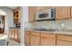 This kitchen features wood cabinets, granite counters, and a tile backsplash at 12118 La Carta Ct, Las Vegas, NV 89138