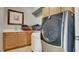 Laundry room with front loading washer and dryer, sink and wooden cabinetry at 12118 La Carta Ct, Las Vegas, NV 89138