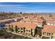 Aerial view of a community showcasing homes with terracotta roofs and desert landscaping at 1525 Spiced Wine Ave # 12103, Henderson, NV 89074