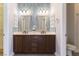 Bathroom featuring a double sink vanity with decorative mirrors and stylish blue tile backsplash at 1525 Spiced Wine Ave # 12103, Henderson, NV 89074