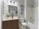 Bathroom featuring a shower over tub, dark vanity, and decorative shelf at 1525 Spiced Wine Ave # 12103, Henderson, NV 89074