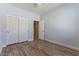 Bedroom featuring luxury vinyl plank flooring, a ceiling fan, and a double door closet at 1525 Spiced Wine Ave # 12103, Henderson, NV 89074