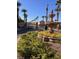 Elegant community entrance with a decorative fountain and palm trees under a clear blue sky at 1525 Spiced Wine Ave # 12103, Henderson, NV 89074