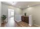 Bright hallway with wood-look floors, recessed lighting, and decorative cabinet with plant at 1525 Spiced Wine Ave # 12103, Henderson, NV 89074