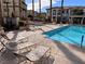 Relaxing pool area featuring lounge chairs and beautiful landscaping in a well-maintained community at 1525 Spiced Wine Ave # 12103, Henderson, NV 89074