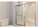 Bathroom featuring a shower with sliding glass doors and white tiled walls at 1525 Spiced Wine Ave # 12103, Henderson, NV 89074