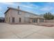 Expansive backyard featuring a concrete patio, rock features, and neutral colored exterior at 1534 Waterford Falls Ave, Las Vegas, NV 89123