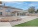 Large backyard featuring a sunroom, rock landscaping, a paved patio, and lush green grass at 1534 Waterford Falls Ave, Las Vegas, NV 89123