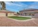 Expansive backyard featuring turf, gravel, pavers, a detached garage, and an attached sunroom at 1534 Waterford Falls Ave, Las Vegas, NV 89123