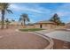 Large backyard offering decorative rock, turf, mature trees, and an expansive driveway at 1534 Waterford Falls Ave, Las Vegas, NV 89123