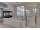 A bright bathroom showcasing a soaking tub, fireplace, and a walk-in glass enclosed shower at 1534 Waterford Falls Ave, Las Vegas, NV 89123