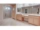 Bright bathroom with a large vanity featuring double sinks, a shower and light-colored cabinets at 1534 Waterford Falls Ave, Las Vegas, NV 89123