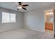 Cozy bedroom with carpet, ceiling fan, and ensuite bathroom at 1534 Waterford Falls Ave, Las Vegas, NV 89123