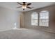 Comfortable carpeted bedroom featuring a ceiling fan and large windows at 1534 Waterford Falls Ave, Las Vegas, NV 89123