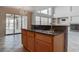 Kitchen island with granite countertop and view to the living room and backyard at 1534 Waterford Falls Ave, Las Vegas, NV 89123